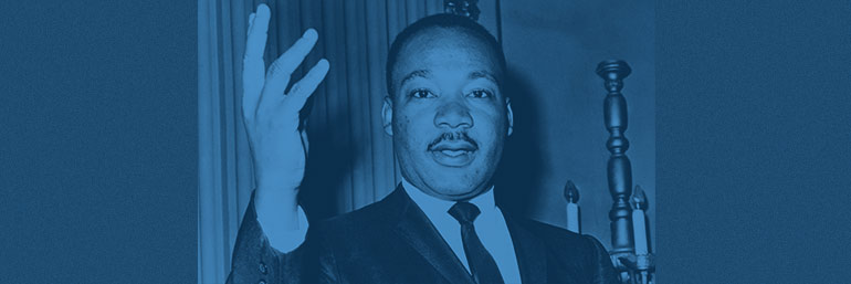 Dr. Martin Luther King Jr. gestures while talking.