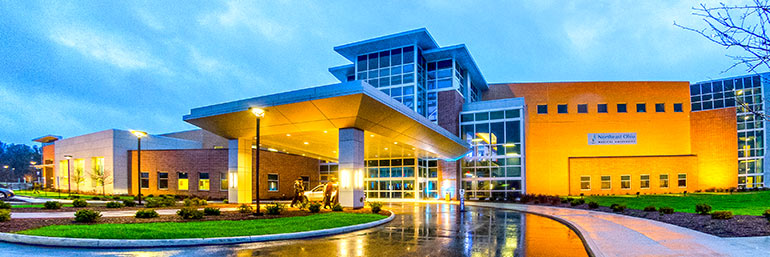 The exterior of NEOMED in Roostown, Ohio at dusk.