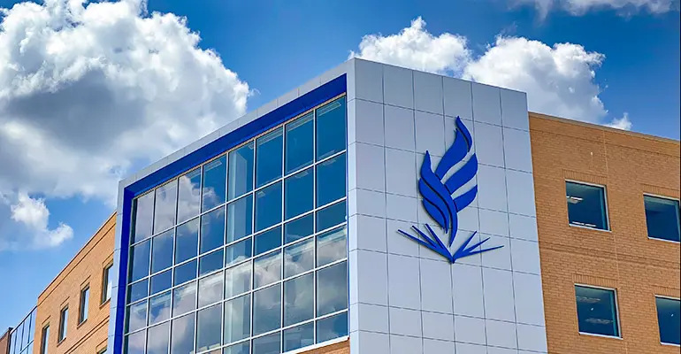 The exterior of NEOMED's building, where a large rendering of our flame logo appears.