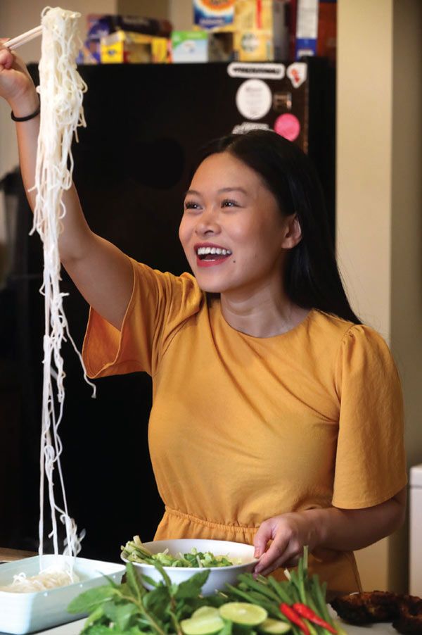 Karen Pham cooks noodles in her kitchen.