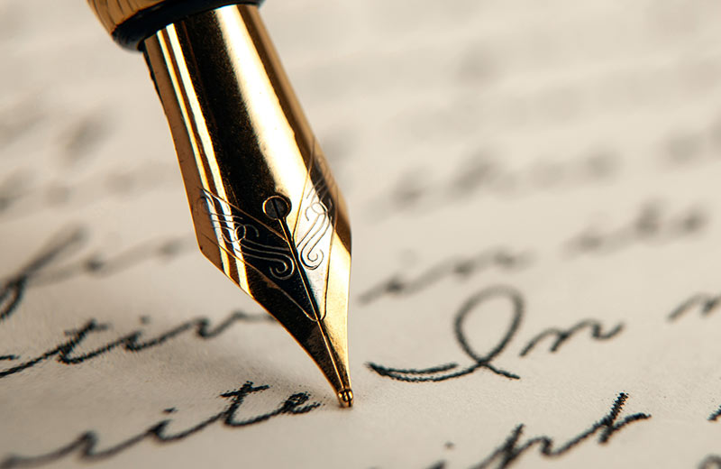 A fountain pen writing cursive.