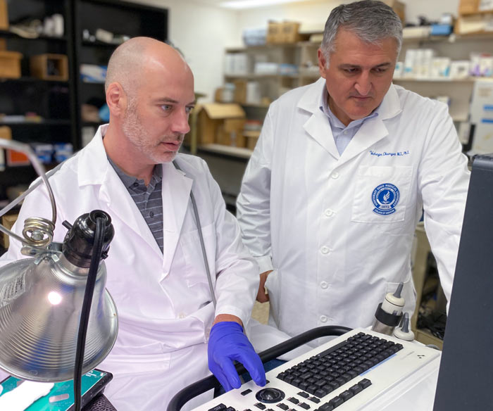 Two NEOMED College of Medicine researchers look at lab results.