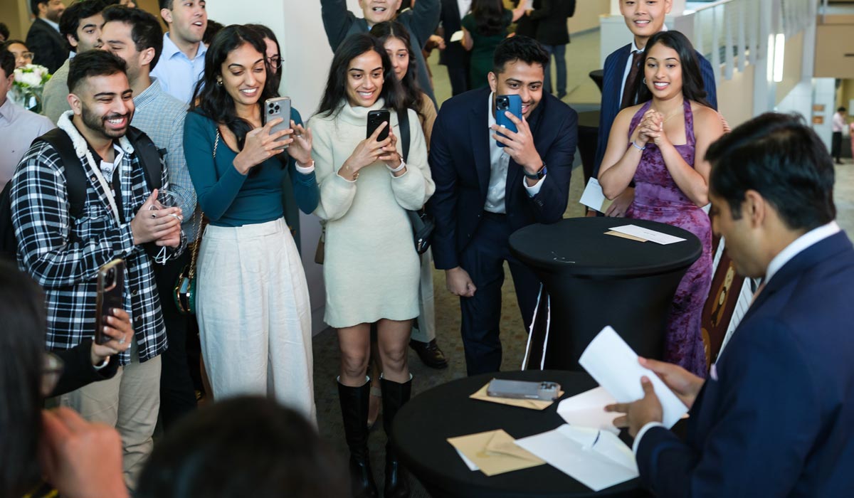 Surrounded by family, a medical student opens the envelope that indicates where he will spend her residency.