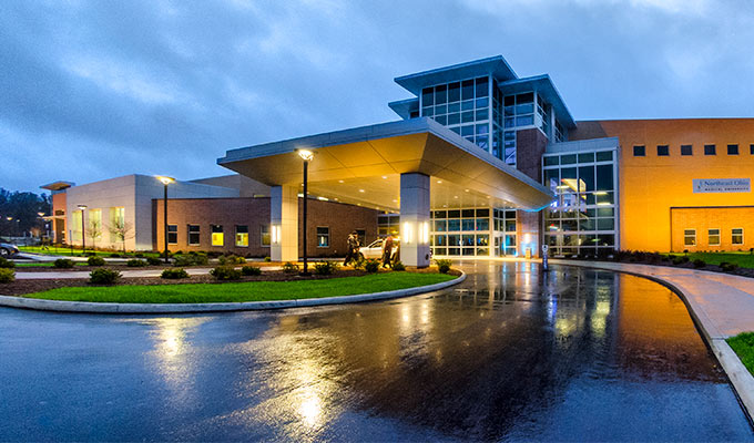 The exterior of NEOMED on a rainy night.