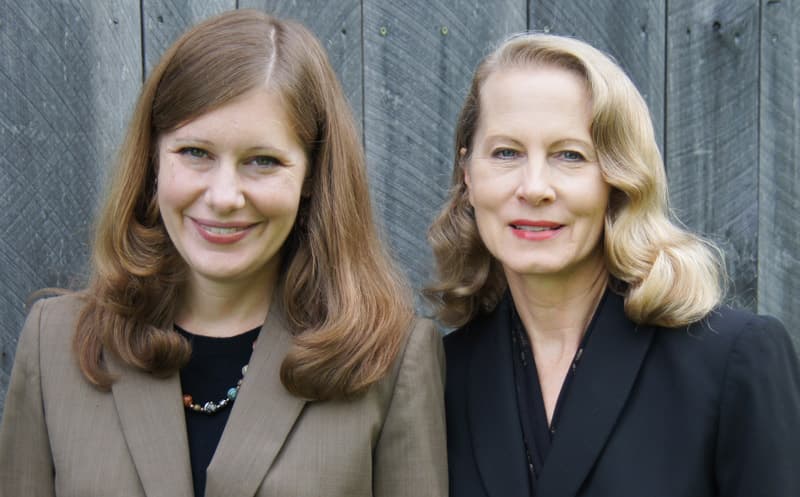 Bethany and Karen Yeiser, speakers at the 2023 Frese Lecture, stand before a wooden fence.