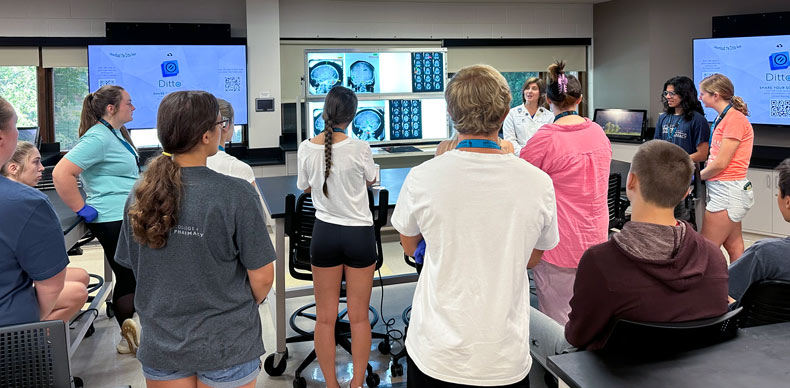 High school students in NEOMED's pharmacy camp listen to a medical professional as she describes medical imaging.