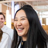 A smiling NEOMED student wearing her white coat for the first time.