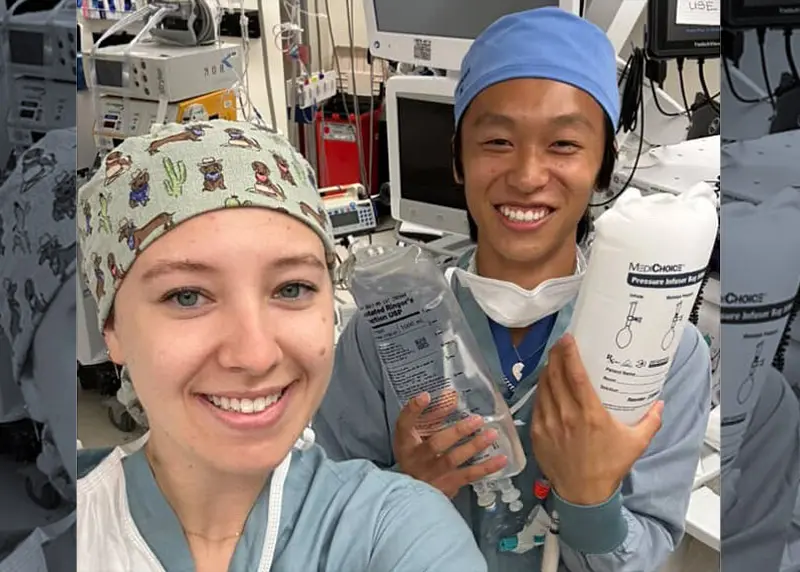 Six people standing outdoors hold lettered signs that spell ‘NEOMED’ while smiling at the camera.