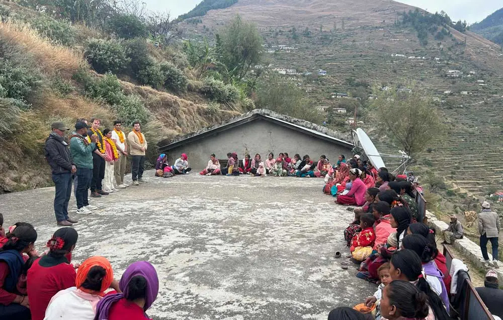 global-health-certificate-1000 Community members in Nepal and visitors from NEOMED sit in a wide circle on a rooftop courtyard in a rural, mountainous setting.