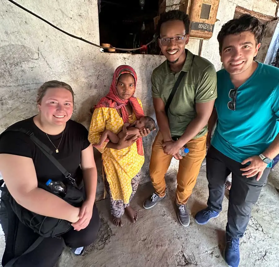 global-health-certificate-900 NEOMED students stand with a Nepali woman holding an infant inside a modest home.