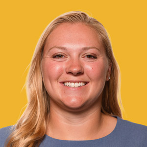 Portrait of Greta Wilker against a gold background