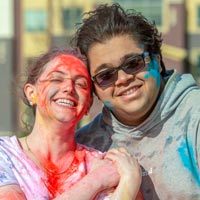 Two students with colors on their face during a campus celebration.