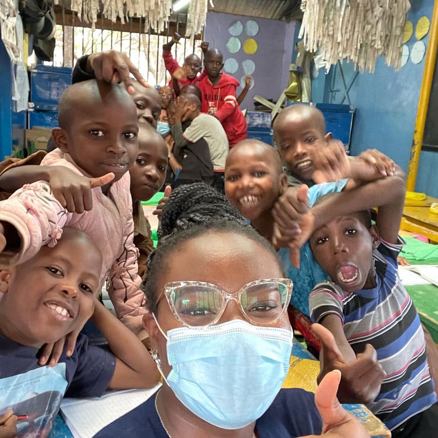 Children in school mug for the camera.