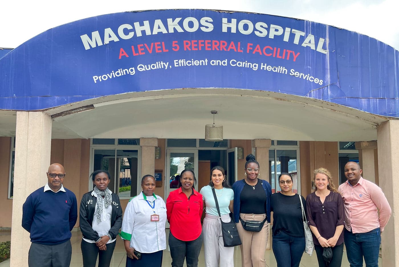 A group of people standing in front of a medical clinic.